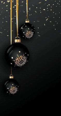 black and gold christmas ornaments hanging from the ceiling