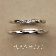 two silver rings with white diamonds on top and the words yuka hojo above them