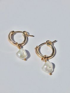 These classy and classic pearl hoop earrings are made using 14k gold fill, so they are safe for sensitive ears. -- Details -- 14k gold fill, pearl charm 12mm 14k gold fill hoops Each piece is handmade with love in my studio in sunny Marina Del Rey, CA. Gold Filled Hoops, Pearl Hoop Earrings, Pearl Charms, Sensitive Ears, Gold Filled, With Love, Hoop Earrings, Gold