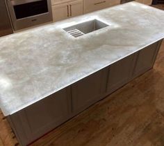 a white counter top in a kitchen next to an oven