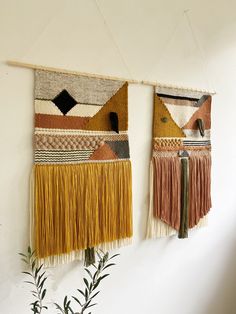 two wall hangings with different colored fringes on them