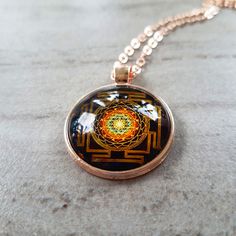 "Sri Yantra sacred geometry necklace . The Sri Yantra, also known as Shree Yantra or Sri Chakra is one of the most powerful and important Yantras to help you fulfill your dreams. It is considered as the mother of all Yantras because they all come from this diagram. Creates material abundance in your life. Sri Yantra has an extraordinary power to fulfill all your wishes and change your life forever. The Sri Yantra benefits and powers should help us to fulfill our desires and make our lives better Spiritual Medallion Jewelry With Si Clarity, Spiritual Rose Gold Jewelry For Meditation, Spiritual Rose Gold Locket Necklace, Spiritual Rose Gold Pendant Necklaces, Gold Locket Necklace In Copper, Gold Copper Medallion Necklace, Gold Medallion Necklace In Copper, Symbolic Round Bronze Necklace, Spiritual Rose Gold Locket Jewelry