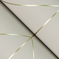 a white and gold wallpaper with lines on the bottom half of it that are diagonally crossed