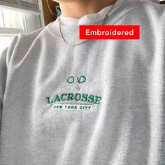 "*SIZES ARE UNISEX* -I'd suggest your usual size for a regular fit, or sizing up for a more relaxed fit. *these sweatshirts are extra comfy when oversized 🥍 \"Lacrosse New York City\" embroidered in green on a comfy vintage-style crewneck. This cute crewneck is inspired by vintage nike sweatshirts. Perfect for any occasion or gift for him or her. A sturdy and warm sweatshirt bound to keep you warm in the colder months. A pre-shrunk, classic fit sweater that's made with air-jet spun yarn for a s Vintage Nike Sweatshirts, Lacrosse Sweatshirt, Sporty Sweater, Style Sweatshirts, Cute Crewneck, Vintage Nike Sweatshirt, Embroidered Gifts, Christian Sweatshirt, Embroidery Sweatshirt