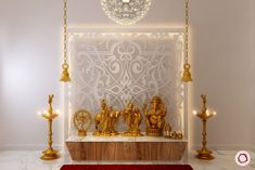 a white room with gold statues and candles on the wall, along with a red rug