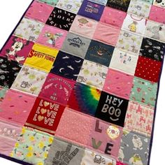 a patchwork quilt with many different types of t - shirts and words on it