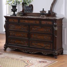 an ornate dresser and mirror in a room