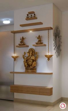 a gold statue is sitting on a shelf in front of a mirror and other decorative items