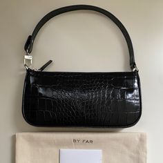 By Far Rachel Bag Color: Black Size : One Size New * Leather: Cowhide Croc-Embossed Leather Zip At Top Dust Bag Included Lined Weight: 9oz / 0.26kg Height: 5in / 13cm Length: 11in / 28cm Depth: 1.5in / 4cm Handle Drop: 7.5in / 19cm Designer Black Handheld Baguette Bag, Luxury Baguette Bag With Zipper Closure For Shopping, Luxury Shopping Baguette Bag With Zipper Closure, Designer Black Pouch Baguette Bag, Designer Black Baguette Pouch Bag, Luxury Black Handheld Baguette Bag, Black Baguette Clutch For Daily Use, Black Clutch Baguette Bag For Daily Use, Black Leather Handheld Baguette Bag