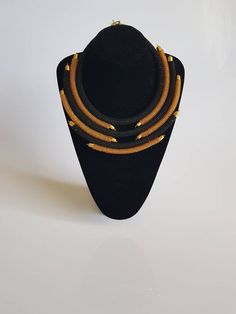 This necklace is 100% handcrafted using fine beads. *Simple yet stylish piece to add to your jewelry set* *Perfect for weddings, African themed events or any other occasion. Main color; gold and black. Dimensions; 18 inches around the neck. **Buy multiple items and pay shipping for 1 item only.The rest ships free. More neckleces here; https://www.etsy.com/shop/TribalTess?ref=seller-platform-mcnav&section_id=21306083 Back to my shop; https://www.etsy.com/shop/TribalTess?ref=seller-platform-mc Gold Necklaces With Black Beads For Party, Gold Bib Necklace With Large Beads For Jewelry Making, Adjustable Gold Beads Necklace, Gold Choker With Black Beads For Parties, Adjustable Gold Beaded Necklaces With Large Beads, Adjustable Gold Beaded Necklace With Large Beads, Elegant Gold Necklaces With Black Beads, Elegant Gold Necklace With Black Beads, Elegant Gold Beaded Necklace With Tiny Beads