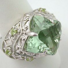 ******Price Is Firm - Final Sale****** Victoria Wieck 6.1ct Prasiolite & Peridot Sterling Silver Ring. Checkerboard-Faceted, Rounded, Geometric Prasiolite (16mm) In Prong Setting. Four-Lobed Frame Features Fleur-De-Lis Designs And Scrolling Metalwork Detail. Wide Shoulders Engraved With Diamond Shapes And Four-Lobe Patterns Accented With Prong-Set, Round Peridot (2mm) Gems. Ring Measures Approx. 11/16" L X 15/16" W. Boxed. Elegant Multi-stone Peridot Gemstones, Green Amethyst Ring For Formal Occasions, Formal Green Amethyst Ring With Accent Stones, Green Amethyst Jewelry With Center Stone, Elegant Green Peridot Gemstones, Fine Jewelry Peridot Gemstones For Formal Occasions, Elegant Green Amethyst Ring In Sterling Silver, Formal Green Amethyst Ring With Gemstone Accents, Fine Jewelry Green Amethyst