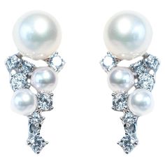 Elevate your style with these exquisite designer stud earrings. Crafted with precision, these earrings are the epitome of elegance and sophistication. They are the perfect addition to your jewelry collection or a thoughtful gift for a loved one. Key Features: 1. Genuine Freshwater Pearls: Each earring features lustrous white freshwater pearls, known for its timeless beauty and natural iridescence. 2. Brilliant Cubic Zirconia Diamonds: The surrounding sparkling cubic zirconia diamonds adds a touc Earring Video, Citrine Earrings Studs, White Gold Earrings Studs, Garnet Earrings, Cubic Zirconia Earrings, Pearl Types, Modern Earrings, Pearl Stud Earrings, Pearl Studs