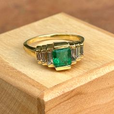 Vintage 14KT yellow gold emerald-cut, natural, emerald and baguette-cut, natural diamond ring. Size 7.75 Can be resized for an additional fee (1) Colombian Emerald Cut Emerald; approx 1 carat Emerald measures: 6.5mm long by 6mm wide (6) Faceted, step-cut, baguette shape diamonds Diamonds .30 carat weight Channel-set in 14KT Yellow Gold Clarity VS2; Color G-H diamonds 5 grams total weight Metal 14KT Yellow Gold no longer stamped but fully tested. Baguette Diamond Ring, Saint Jewelry, Pearl Accessories, Baguette Diamond Rings, Natural Diamond Ring, Step Cut, White Gold Necklaces, Square Diamond, Yellow Gold Bracelet