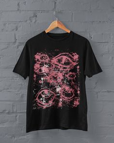 Thanks for stopping by! Grunge Eyes T-shirt Printed on a super soft, cotton tee Dispatched in 5 working days or sooner Unisex Free UK delivery Material: 100% ringspun cotton. Chest (to fit): S  34/36   M  38   L  40/42   XL  44/46   XXL  48/50 ECO-FRIENDLY Each garment is made to order, reducing extra material and energy that would be otherwise wasted We use DTG printing process which is easier on the environment than screen-printing Our ink is bright and also eco-friendly. Do not tumble dry. Wa Punk Tops With Funny Print For Alternative Fashion, Emo Style Unisex Short Sleeve Tops, Grunge Anime Print Tops For Alternative Fashion, Alternative Graphic Tops For Alternative Fashion, Alternative Fashion Graphic Design Tops, Black Grunge Top With Custom Print, Grunge Custom Print Tops For Concert, Grunge Tops With Custom Print For Concert, Emo Graphic Design Tops For Concerts