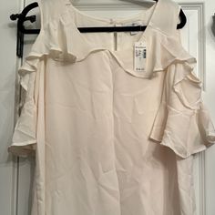 Beautiful Cream Cold Shoulder Blouse Large Orders Received Before 1 Pm Mon-Fri Will Be Shipped Same Day! Thanks For Taking Time To Look At My Closet Have A Great Day! Elegant Flowy Tops For Summer, Elegant Off White Short Sleeve Top, Cream Flowy Blouse For Summer, Cream Tops For Summer Workwear, Flowy Cream Blouse For Summer, White Ruffled Blouse For Daytime, Cream Tops For Workwear In Summer, Elegant Summer Blouse For Daytime, Elegant Daytime Summer Blouse