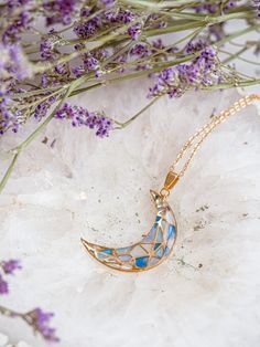 Experience celestial beauty with our Stainless Steel Crescent Moon Pendant, a uniquely handcrafted jewelry piece perfect for moon lovers and mystics alike. Each moon cradle is carefully filled with different shades of iridescent blue resin, creating a stained glass effect that is both enchanting and eye-catching. Crafted from high-quality, durable stainless steel, this crescent moon pendant boasts lasting shine and resilience. Its design is a testament to intricate craftsmanship, capturing the m Celestial Necklaces With Sun And Moon Design For Gift, Celestial Sun And Moon Design Necklace As Gift, Moon Shaped Brass Necklace For Gift, Moon-shaped Brass Necklace For Gift, Celestial Round Pendant Necklace For Gifts, Mystical Clavicle Chain Jewelry For Gift, Mystical Clavicle Chain Jewelry As Gift, Celestial Round Crystal Necklace For Gift, Half Moon Brass Necklace For Gift