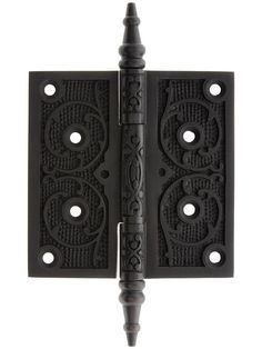 a pair of black iron door hinges with decorative designs on the front and back