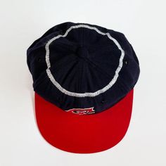 "Here is a rare display item from the \"Golden Age of Baseball\". Offered is an original California Angels KM Pro cap from the 1960s. The cap features the California Angels interlocking \"CA\" logo on the front, red bill and silver halo stitched around the crown. The six-point crown suspension's interior is lined with a leather sweatband that is home to a vintage \"KM Pro\" label. This cap is labeled as a size \"7\". Features - Color: navy, silver and red - Interlocking \"CA\" logo on the front Retro Snapback Fitted Hat For Sports Events, Vintage Visor Hat For Baseball Season, Retro Six-panel Baseball Cap For Sports, Retro Sports Baseball Cap, Retro Visor Baseball Cap, Retro Fitted Hat With Curved Brim For Sports Events, Retro Curved Brim Fitted Hat For Sports Events, Retro Six-panel Baseball Hat, Retro Six-panel Hat For Baseball Season