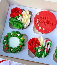 four cupcakes in a box decorated with christmas decorations