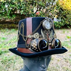 "This beautiful Steampunk Party Hat is made of 100% finest quality and hand-painted craftsmanship. The hat is decorated with a pocket watch décor in the center. With a removable goggles. Occasion: Great for Steampunk, Halloween, Music Festival, Burning Man, Masquerade Party, and more. Color: Black Brown Inside Measurement: Length: 8\" Width: 7\" Depth of Hat: 6\"" Black Steampunk, Steampunk Party, Steampunk Pocket Watch, Steampunk Halloween, Steampunk Hat, Steam Punk Jewelry, Steampunk Cosplay, Kentucky Derby Hats, Masquerade Party