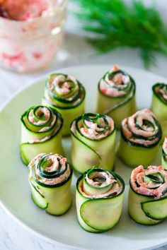 cucumber rolls with cream cheese and dill pickles on a white plate