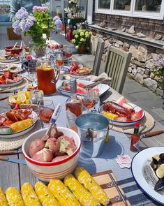 a table with corn, potatoes and other food on it