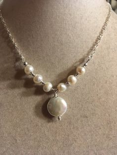 This pearl necklace is made of white freshwater pearls, sterling silver: chain, spring ring clasp and findings. This necklace measures 18 inches in length and the pearl pendant measures about 1/2 inch. All of our jewelry is unique and custom designed. Most of our jewelry can easily be resized. If there is a piece of jewelry that you are interested in, but would like some changes made, please do not hesitate to contact us. We appreciate your shopping with Jewelry by CARMAL and hope you will do so Adjustable Pearl Drop Necklace For Anniversary, Single Strand Pearl Silver Jewelry, Single Strand Pendant Jewelry For Wedding, Sterling Silver Round Beads Jewelry For Anniversary, Pearl Necklaces With Round Beads For Anniversary, Silver Pearl Jewelry With Pearl Drop, Adjustable Pearl Chain Necklace For Anniversary, Silver Single Strand Jewelry With Round Pendant, Silver Single Strand Necklace With Round Pendant