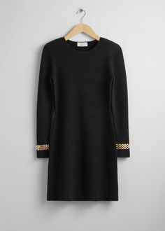 Wool knit mini dress featuring padded shoulders and gold-toned chain bracelets at the cuffs.• Ribbed finish• Round neckline• Certified according to the Responsible Wool Standard (CU815571)Length of dress: 90cm / 35.4" (Size S)