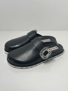 Roger Vivier Slidy Crystal-buckled Leather Backless Loafers size 37. New never worn with box and dust bag. Size 37, fits us size 7 Fainted scratches on the right shoe from handling. 100% Authentic guaranteed Retail for $1200 Made from polished black leather, they're embellished with signature crystal strass buckles for a bit of glamour, while ergonomic footbeds and shark-tooth soles lend them practicality. upper: leather lining: leather sole: leather insole, rubber sole round toe Made in Italy Line cross the label as final sale Designer Calf Leather Mules With Buckle Closure, Designer Loafers With Buckle Closure, Luxury Calf Leather Mules With Buckle Closure, Designer Calf Leather Loafers With Buckle Closure, Luxury Formal Mules With Tang Buckle, Luxury Slip-on Mules With Removable Insole, Luxury Leather Loafers With Buckle Closure, Designer Leather Mules With Tang Buckle, Luxury Slip-on Loafers With Buckle Closure