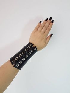 Punk Style Leather Cuff Bracelet With Wrist Strap, Punk Style Leather Cuff Bracelet, Adjustable Punk Wristband, Black Leather Punk Bracelet With Wrist Strap, Gothic Leather Jewelry For Festival, Black Rock Jewelry, Punk Style Black Wristband For Festivals, Black Punk Wristband With Wrist Strap, Black Punk Wristband For Concert