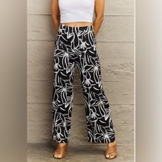 Pattern Type: Floral Style: Casual Features: Basic Style Length: Long Material Composition: 100% Polyester Care Instructions: Machine Wash Cold. Tumble Dry Low. Imported Product Measurements: S: Length 39.8 In, Inseam 28.1 In, Waist 26.9 In, Hip 38.2 In M: Length 40.1 In, Inseam 28.3 In, Waist 28.5 In, Hip 39.8 In L: Length 40.4 In, Inseam 28.3 In, Waist 30.8 In, Hip 42.1 In Xl: Length 40.6 In, Inseam 28.3 In, Waist 33.2 In, Hip 44.5 In Chic Printed Vacation Pants, Chic Printed Pants For Vacation, Chic Floral Print Beach Pants, Chic Beach Pants With Floral Print, Trendy White Floral Print Pants, Chic Black Printed Pants, Casual Black Floral Print Pants, Black Printed Wide-leg Pants, Black Floral Print Vacation Bottoms