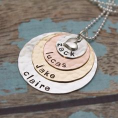 "This is my most popular necklace for mothers, grandmothers, or pet lovers! I begin with a 1/2\" sterling silver disc (9 characters max), then a 3/4\" copper disc (12 character max), a 1\" brass disc(16 character max) and last a 1-1/4\" silver disc (20 character max). All discs are hammered and are personalized with names of your choice. The pendant is topped with a sterling silver heart charm. Hangs from a sterling silver chain. **Please read my store policy about copper and brass jewelry befor Round Pendant Necklace With Hallmark For Mother's Day, Nickel-free Necklace For Mother's Day Personalized Gift, Hand Stamped Round Disc Necklace For Mom, Hand Stamped Round Pendant Necklace For Mom, Hand Stamped Round Pendant Necklace As Gift For Mom, Sterling Silver Round Pendant Name Necklace For Mom, Round Necklace With Hallmark For Mother's Day, Round Mother's Day Necklace With Hallmark, Personalized Gift Round Pendant Necklace