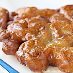 there is a white plate with donuts on it and a fork next to it