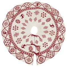 a red and white table cloth with reindeers, snowflakes and stars on it