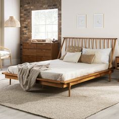 a bed sitting on top of a white rug next to a wooden dresser and chair