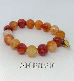 10mm round orange crab fire agate beads Gold plated charm Adjustable Orange Bracelets With 8mm Beads, Adjustable Orange Agate Bracelet, Orange Stretch Bracelet With 8mm Beads, Adjustable Orange Agate Bracelets, Orange Round Faceted Beads Jewelry, Handmade Orange Agate Bracelets, Handmade Orange Agate Bracelet, Handmade Orange Stretch Bracelet With Round Beads, Handmade Orange Bead Stretch Bracelet