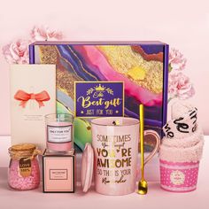 a pink gift box filled with personal care items and gifts for the woman in your life