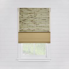 a window in a white room with a tan roman blind on top of the blinds