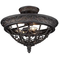 an ornately designed ceiling light fixture with two lights on each side and one light in the middle