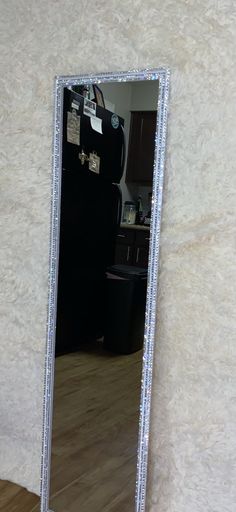 a large mirror sitting on top of a wooden floor