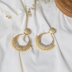 Define beauty and elegance with these Unique and Designer Handmade Gold & Silver Dangle Earrings. The earrings are finely crafted with a round stud and an ethnic dangler. The earrings are plated in dual-tone (gold and silver) and have a beautiful texture. These are just perfect for any special occasion or a happy day! Details: Brass Metal Gold & Silver Plating Handmade Dangle/Drop Earrings Ethnic Earrings Hypoallergenic Nickel & Lead-free Elegant Metal Chandbali Bridal Earrings, Elegant Chandbali Bridal Earrings For Pierced Ears, Elegant Chandbali Bridal Earrings In Metal, Elegant Bridal Chandbali Earrings, Gold Chandbalis For Anniversary, Metal Earrings With Elegant Design For Anniversary, Elegant Drop Clip-on Earrings With Latkans, Elegant Metal Hoop Earrings For Celebration, Elegant Metal Earrings For Anniversary