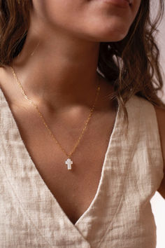 This shimmery Mother of Pearl Cross Necklace is the perfect spring white to add to your wardrobe (or jewelry box)!
Handmade by Token Jewelry and waterproof, hypoallergenic, and nickel free. White Cross Necklace With Adjustable Chain, Elegant White Cross Necklace With Adjustable Chain, Dainty White Cross Necklace, White Cross Necklace As A Gift, White Cross Necklace For First Communion, Dainty White Cross Jewelry, White Crucifix Cross Necklace, White Spiritual Crucifix Cross Necklace, White Minimalist Cross Jewelry