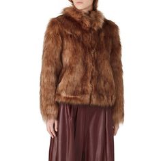 Mocha brown faux fur (80% Acrylic, 20% Modacrylic). Jacket. Long sleeves. Pockets. Satin lining. 21" from shoulder to hemline. Imported. Brown Faux Fur Winter Outerwear, Brown Fur Coat With Faux Fur Lining, Brown Fur Coat With Faux Fur Trim, Brown Long Sleeve Fur Coat With Faux Fur Trim, Fall Mink Color Fur Coat With Faux Fur Trim, Chic Brown Fur Coat For Fall, Brown Faux Fur Outerwear With Feather Trim, Brown Faux Fur Lined Outerwear, Brown Faux Fur Trim Coat For Fall