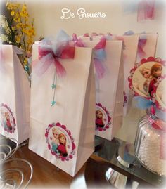 there are many bags with pictures on them and ribbons around the handles that have been tied together