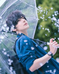 a woman holding an umbrella and blowing bubbles