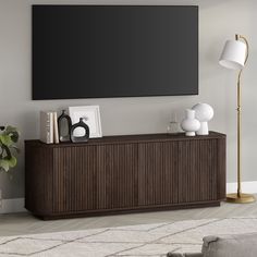 a large flat screen tv mounted to the side of a wooden cabinet in a living room