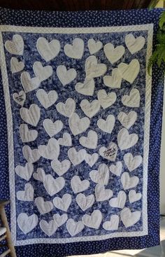 a blue and white quilt with hearts on it