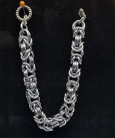 This byzantine rope chain bracelet is simple in its design. It is also lightweight, and holds up well. The design is such that it would look good on a large or small wrist size, just be sure to specify the desired length in the personalization options. This is annodized aluminum, making it lightweight, and the black ice color gives it a hint of blue or purple in the right lighting. Charms can be added - message me to start a custom order. Metal Wheat Chain Bracelets As Gifts, Silver Metal Jewelry With Wheat Chain, Silver Sterling Wheat Chain Bracelet, Silver Wheat Chain Bracelet As Gift, Silver Wheat Chain Bracelet Gift, Silver Jewelry With Wheat Chain, Silver Rope Chain Bracelet As Gift, Silver Rope Chain Bracelet Gift, Brutalist Design