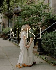 a man and woman standing next to each other in front of a building with the words maisie on it