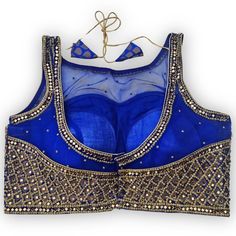 Indulge in regal sophistication with our Mirror and Stonework Blouse in Royal Blue. Immerse yourself in the allure of hand-embellished diamond-shaped stones and opulent gold accents on the lustrous blue canvas. The gracefully curved neckline adorned with meticulous handwork exudes an air of timeless elegance. This blouse is a statement piece that seamlessly complements various sarees and lehengas, making it a versatile wardrobe essential for the discerning fashion enthusiast. Elevate your style Best Mirror, Reception Outfits, Curved Neckline, Cool Mirrors, Sari Blouse, Fashion Enthusiast, Versatile Wardrobe, Blue Mirrors, Blue Canvas